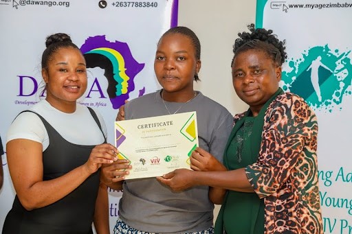 HIV advocate receiving her certificate after the training of 15 Adolescent Girls and Young Women